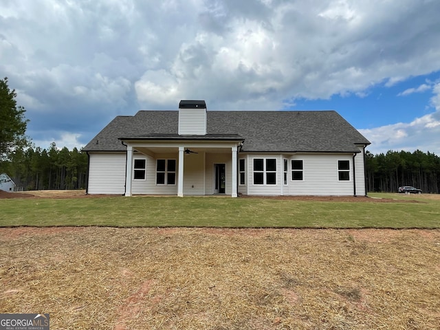 rear view of house with a lawn