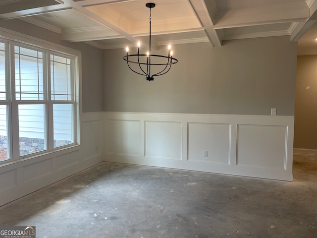 unfurnished dining area with beamed ceiling, concrete floors, coffered ceiling, an inviting chandelier, and ornamental molding