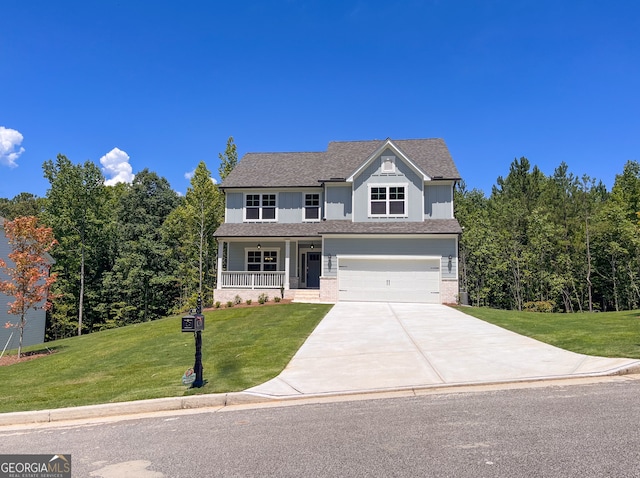 front of property featuring a porch, a garage, and a front lawn