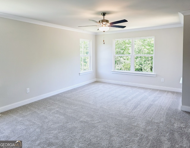 unfurnished room featuring carpet, a healthy amount of sunlight, and ornamental molding