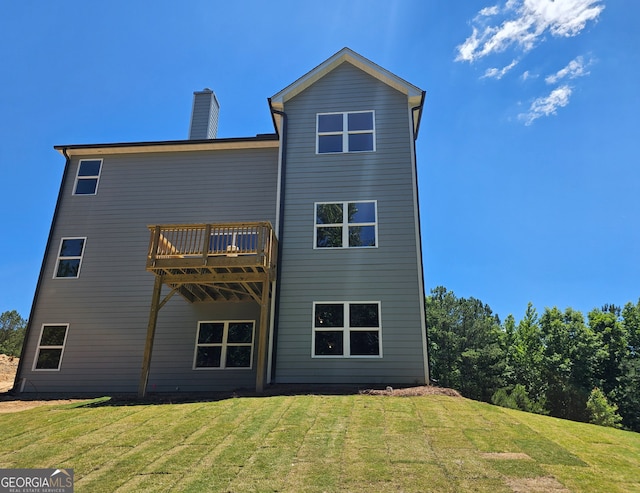 back of house featuring a yard and a deck