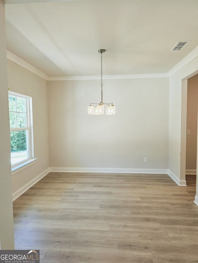 unfurnished room featuring light wood-type flooring and ornamental molding