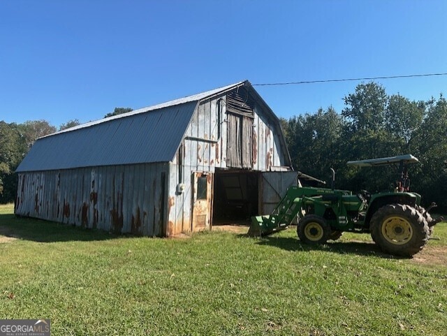 view of outbuilding with a yard