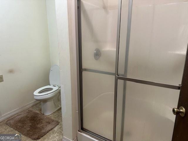 bathroom featuring toilet and walk in shower