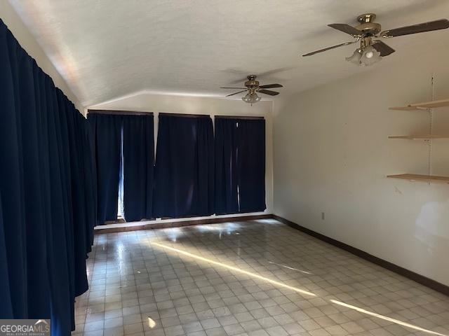 spare room featuring ceiling fan and lofted ceiling