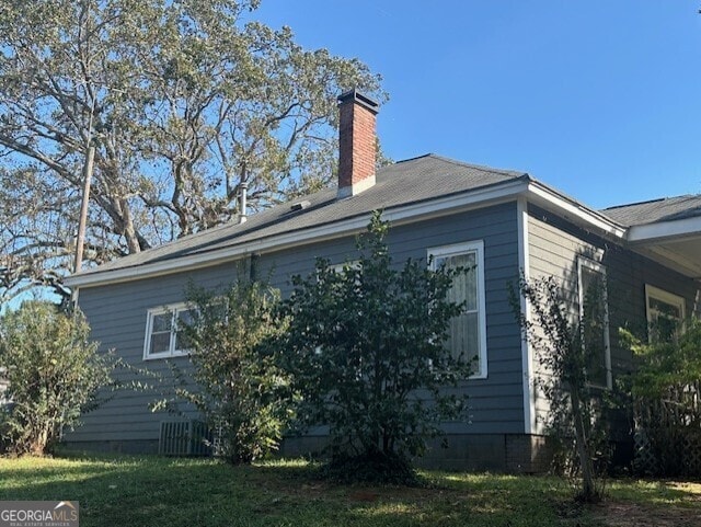 view of property exterior with a yard