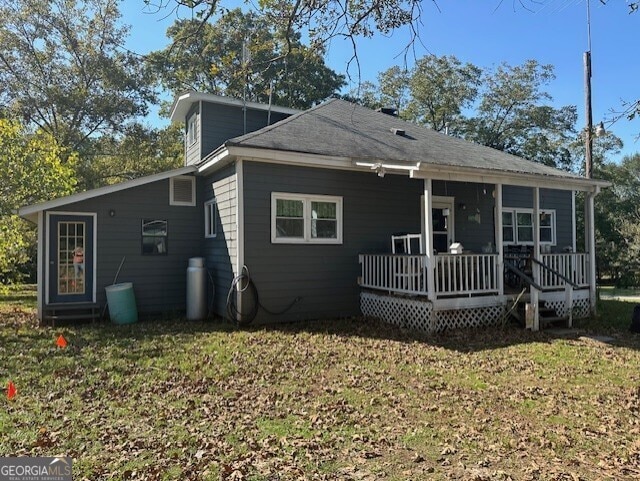 back of property featuring a lawn