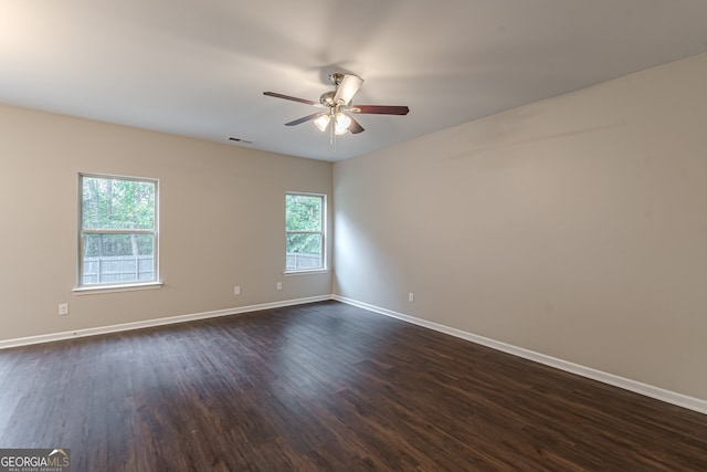 unfurnished room with dark hardwood / wood-style flooring, ceiling fan, and plenty of natural light