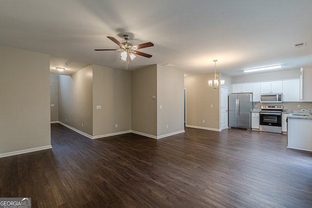 unfurnished living room featuring sink, dark wood-type flooring, and ceiling fan with notable chandelier