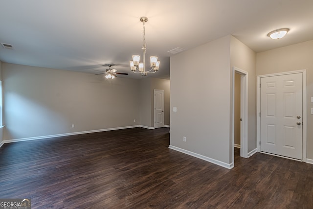 unfurnished room featuring ceiling fan with notable chandelier and dark hardwood / wood-style floors