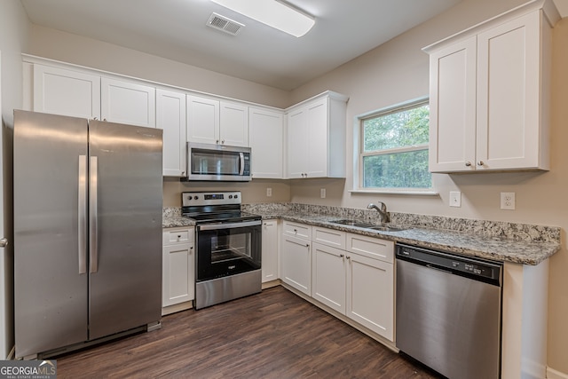 kitchen featuring white cabinets, sink, and appliances with stainless steel finishes