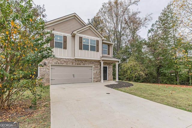 view of front of home featuring a front yard and a garage