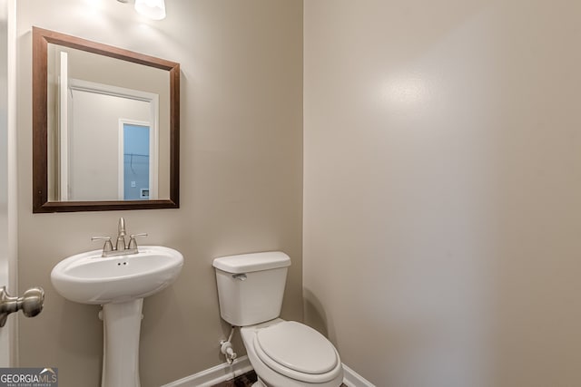 bathroom with toilet and sink