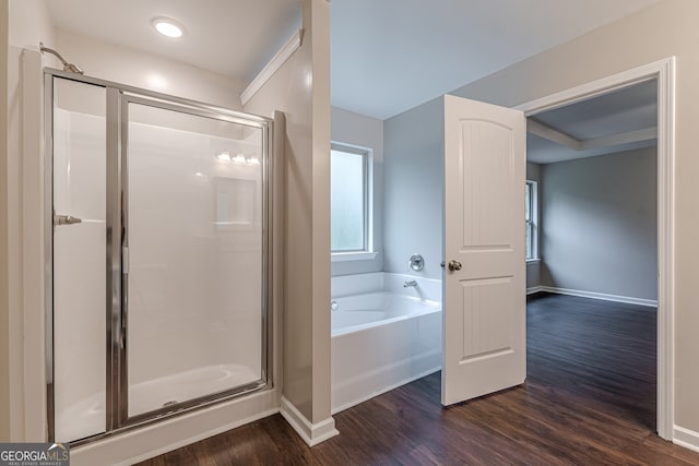 bathroom with hardwood / wood-style floors and shower with separate bathtub