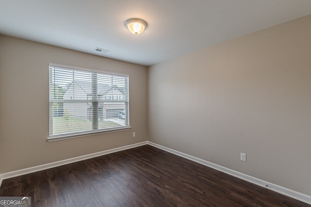 spare room featuring dark wood-type flooring