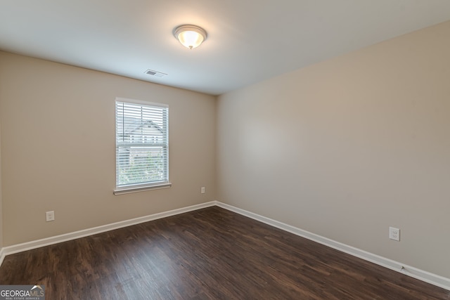 empty room featuring dark wood-type flooring