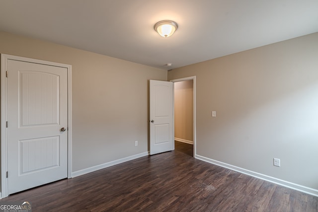 unfurnished bedroom with dark hardwood / wood-style flooring