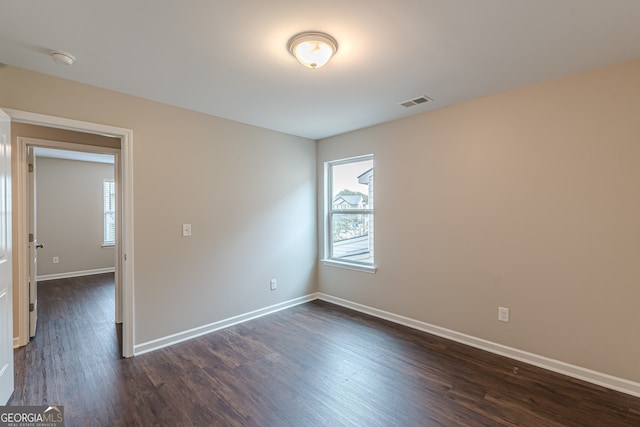 unfurnished room featuring dark hardwood / wood-style flooring