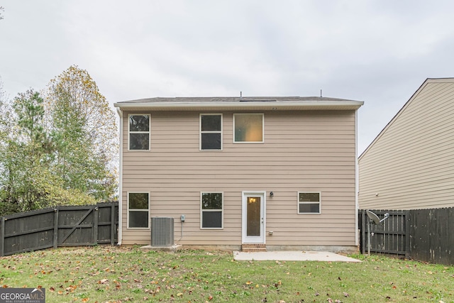 back of house with a patio area, a yard, and cooling unit