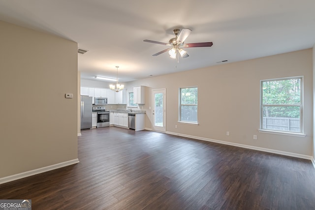 unfurnished living room featuring sink, ceiling fan with notable chandelier, and dark hardwood / wood-style floors