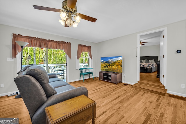 living room with light wood-type flooring and ceiling fan