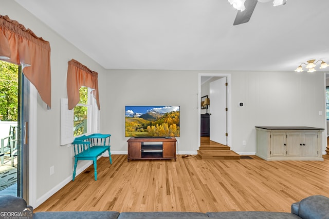 living room featuring ceiling fan and light wood-type flooring