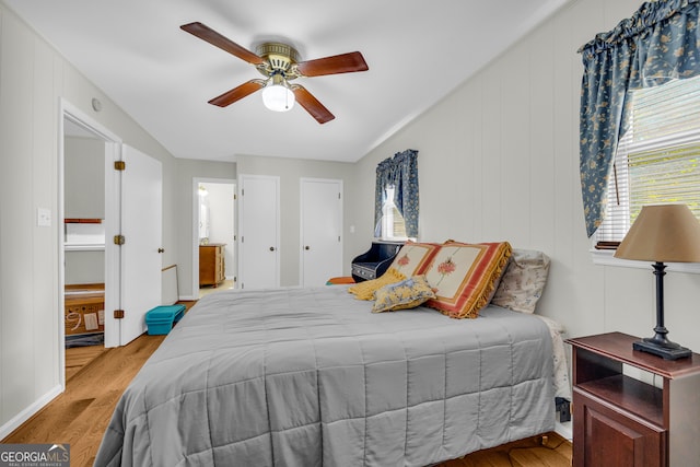 bedroom featuring light hardwood / wood-style floors, connected bathroom, and ceiling fan