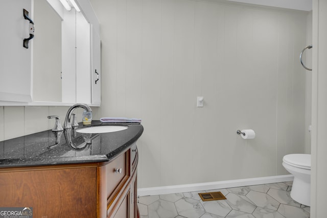 bathroom featuring vanity and toilet