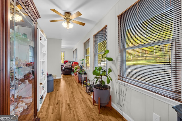 corridor with light hardwood / wood-style floors