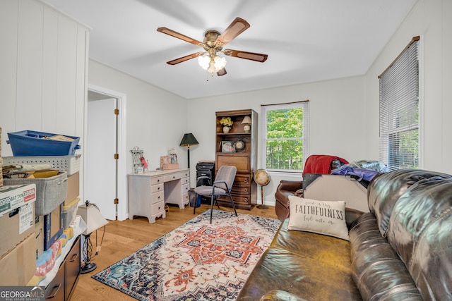 living room featuring light hardwood / wood-style flooring and ceiling fan