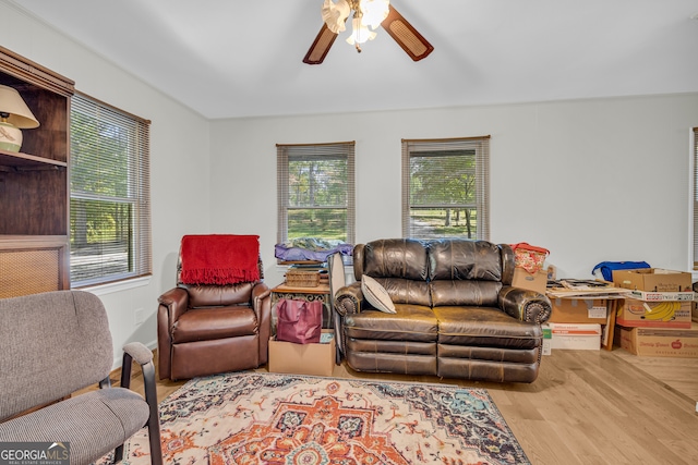 living room featuring light hardwood / wood-style floors, a healthy amount of sunlight, and ceiling fan