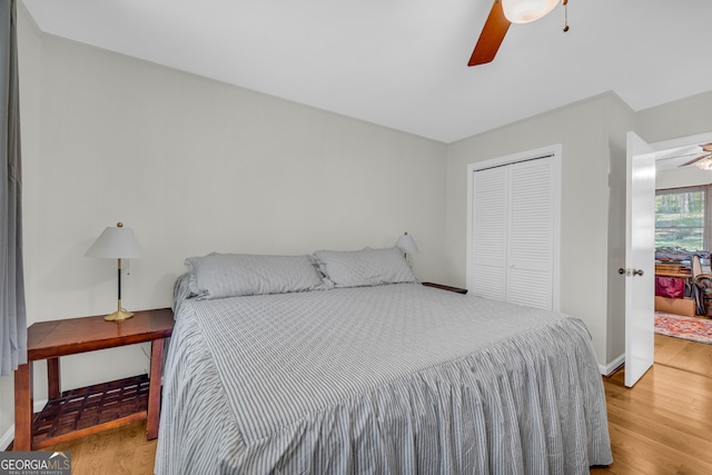 bedroom with a closet, ceiling fan, and wood-type flooring