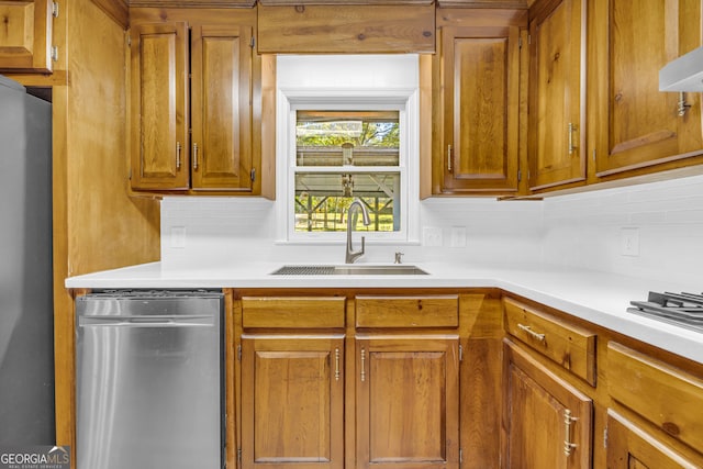 kitchen featuring extractor fan, decorative backsplash, sink, and appliances with stainless steel finishes