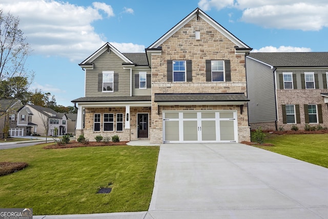 craftsman house with a front yard and a garage