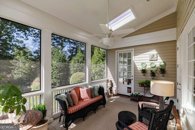 sunroom with ceiling fan, a healthy amount of sunlight, and lofted ceiling with skylight