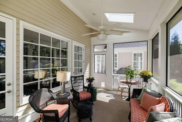 sunroom / solarium with ceiling fan and lofted ceiling with skylight