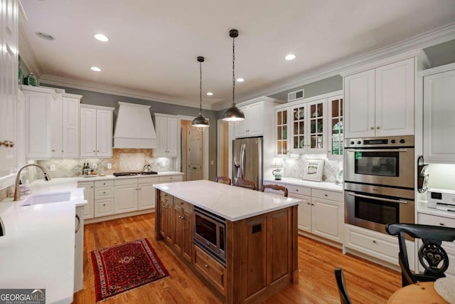 kitchen featuring white cabinets, appliances with stainless steel finishes, and sink