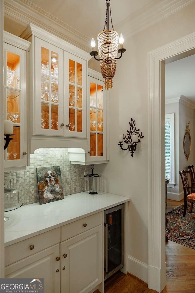 bar featuring white cabinets, wine cooler, decorative light fixtures, and tasteful backsplash