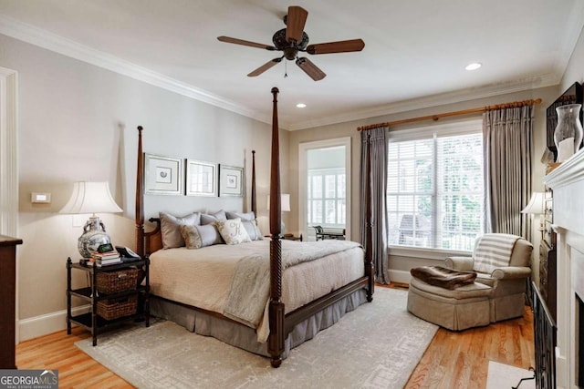 bedroom featuring ceiling fan, crown molding, and light hardwood / wood-style floors