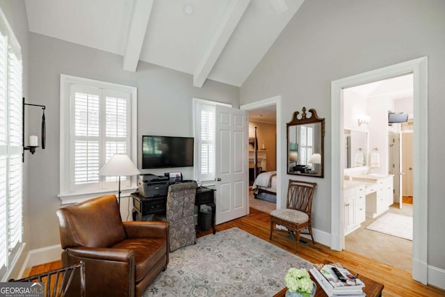 living room with wood-type flooring and vaulted ceiling with beams