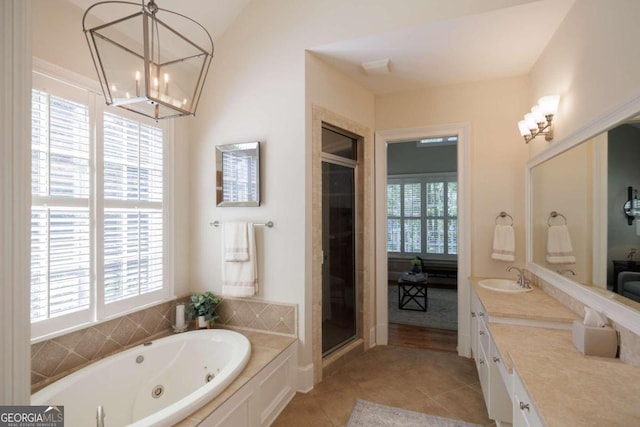 bathroom featuring tile patterned flooring, separate shower and tub, vanity, and vaulted ceiling