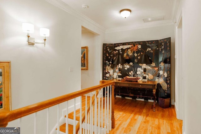 hall with ornamental molding and hardwood / wood-style flooring