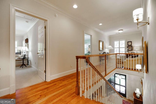 hallway featuring a notable chandelier, crown molding, and hardwood / wood-style flooring