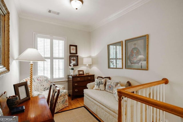 interior space featuring ornamental molding and light hardwood / wood-style flooring