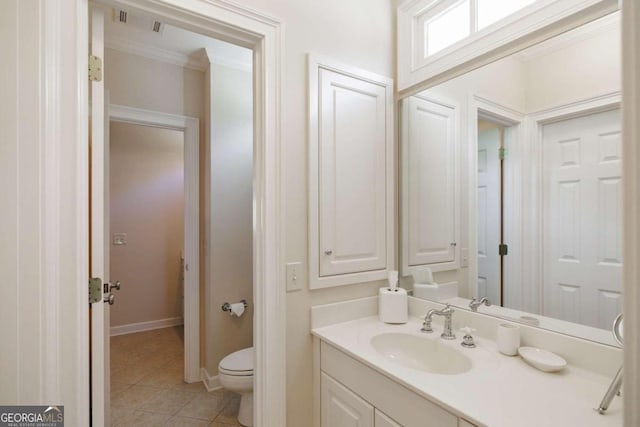 bathroom featuring ornamental molding, vanity, toilet, and tile patterned floors