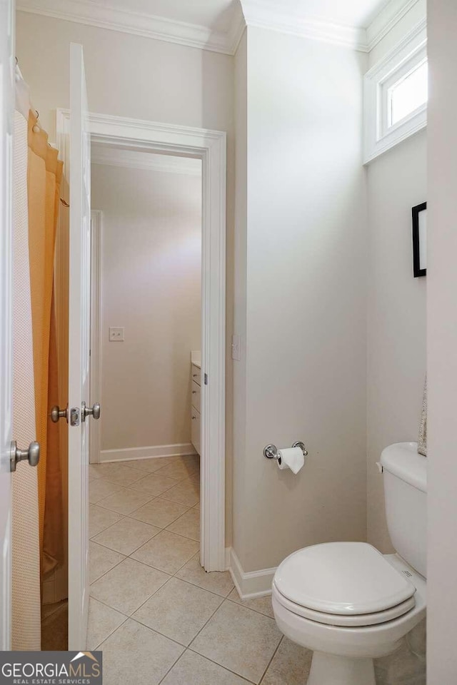 bathroom with crown molding, tile patterned floors, and toilet