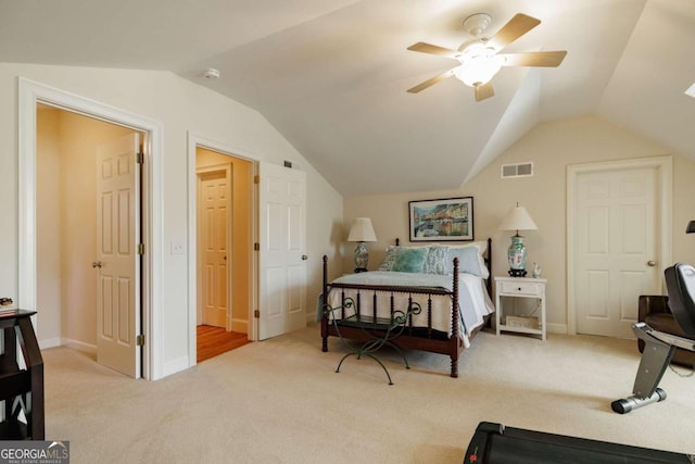 bedroom featuring light carpet, vaulted ceiling, and ceiling fan