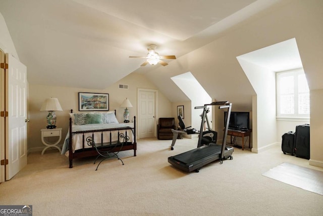 exercise area featuring ceiling fan, lofted ceiling, and light carpet