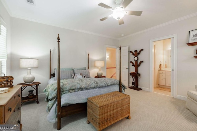 carpeted bedroom featuring ornamental molding, ensuite bathroom, and ceiling fan