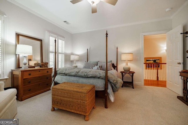 bedroom featuring ornamental molding, ceiling fan, and light colored carpet